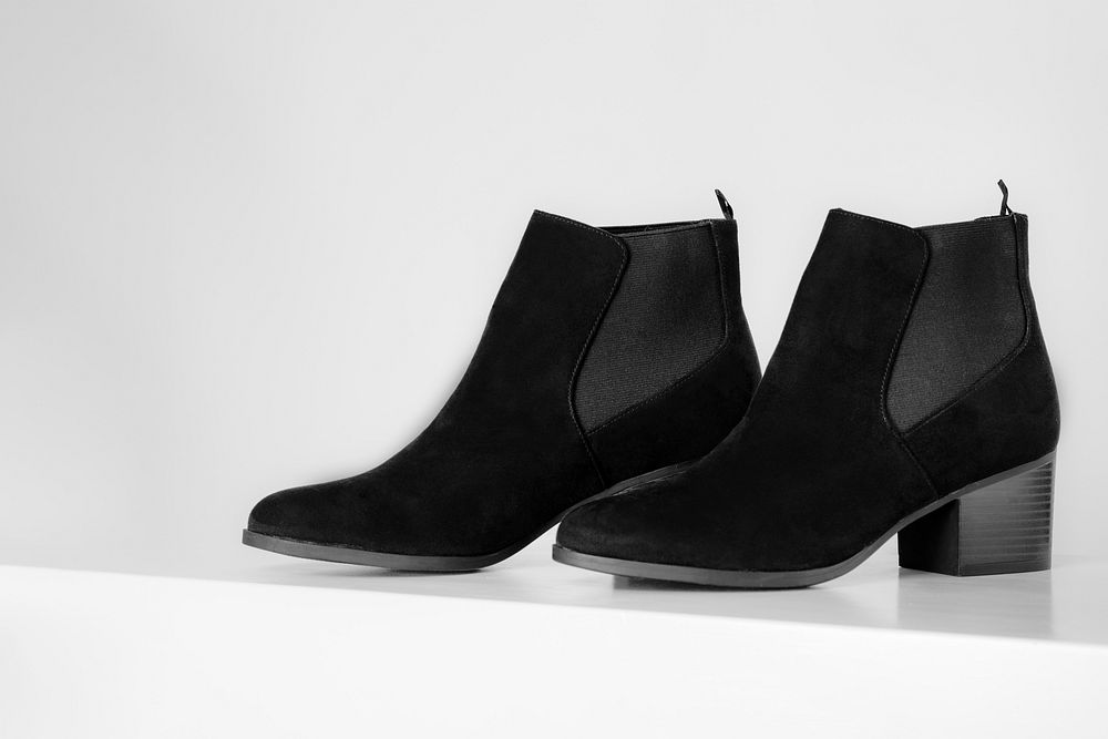 Black ankle boots on a white background