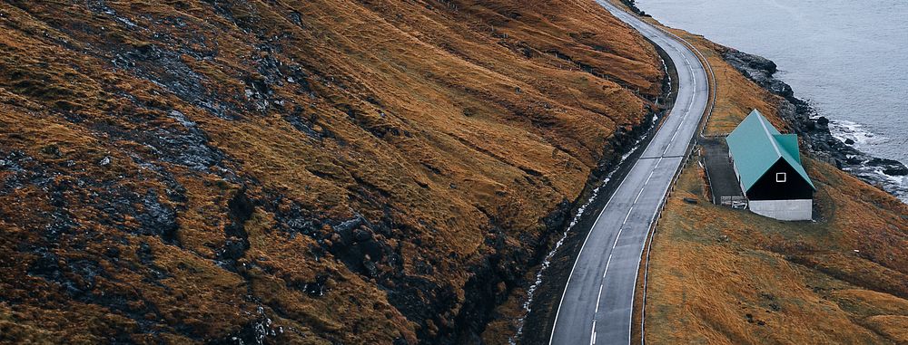 Scenic freeway by the lake on Faroe Islands banner