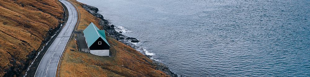 Scenic freeway by the lake on Faroe Islands banner