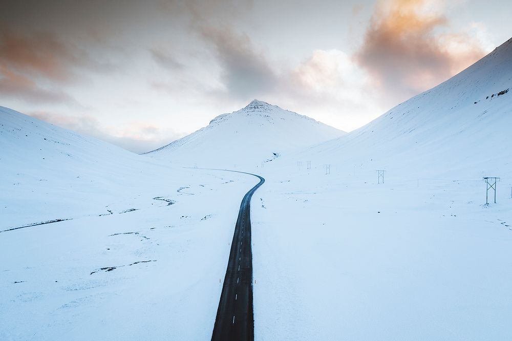 Long black road on the white winter landscape