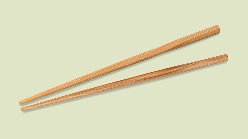 Wooden chopsticks on green background