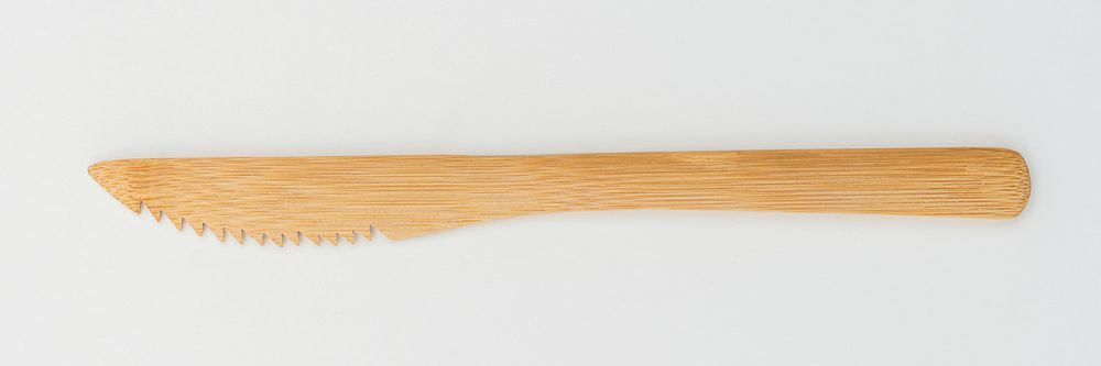 Wooden knife on off white background