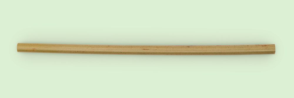 Reusable bamboo wood straw on green background