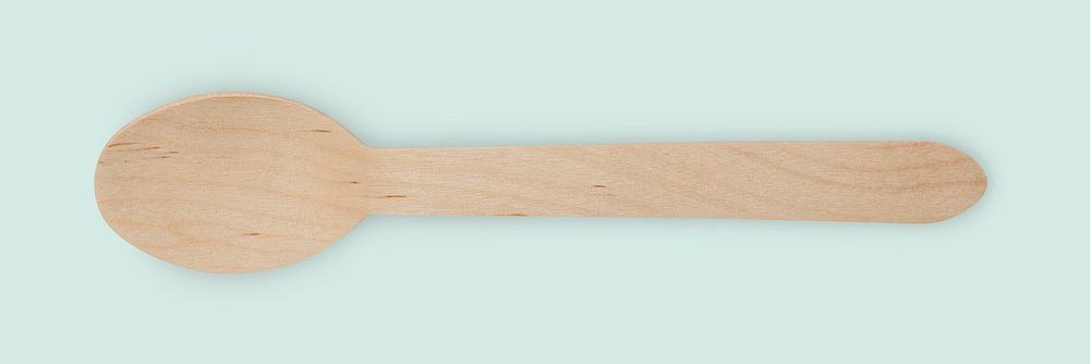Natural wooden spoon on off blue background banner