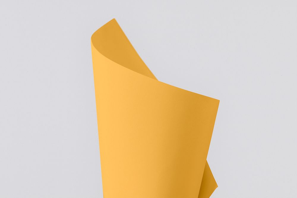 Blank orangish yellow folded paper on a gray background