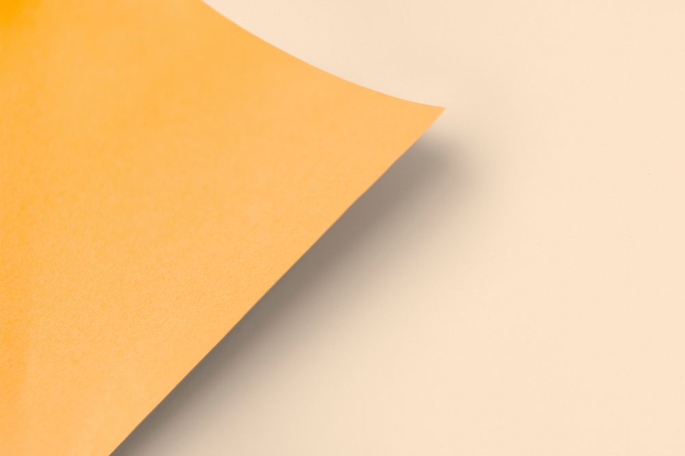 Blank orange paper mockup on a light orange background