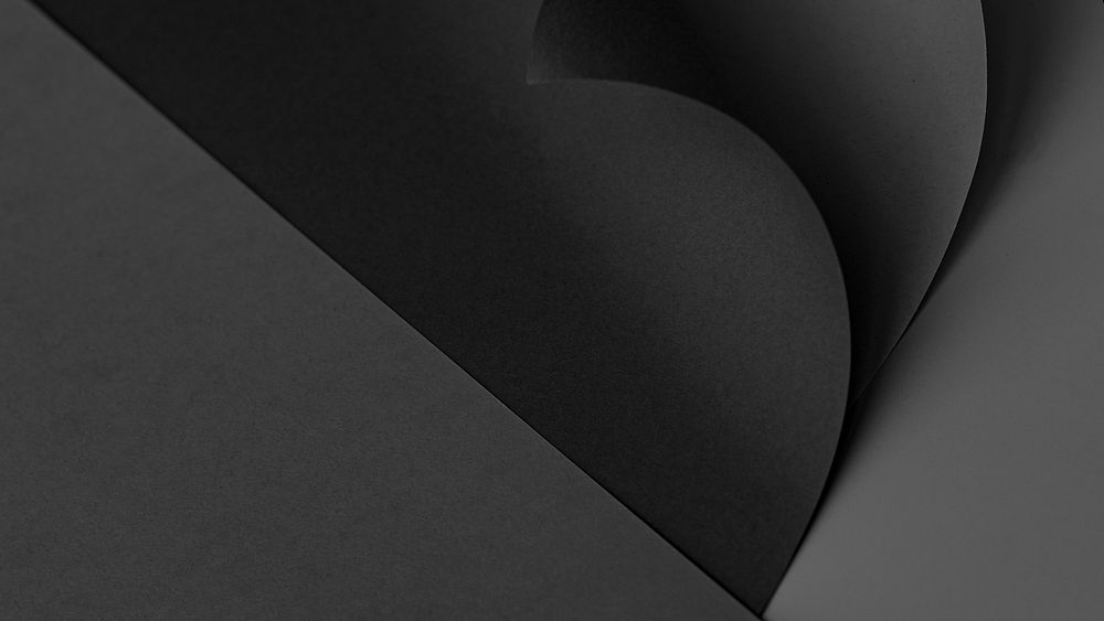 Curled black chart paper on a dark gray background