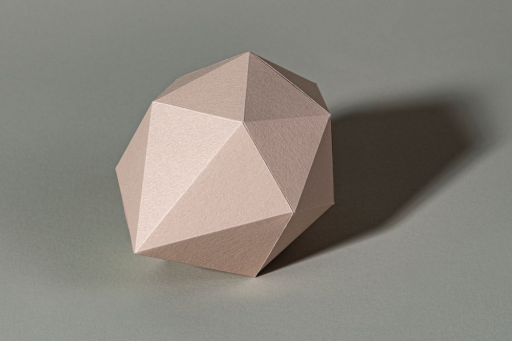 3D pink pentagon shaped paper craft on a gray background