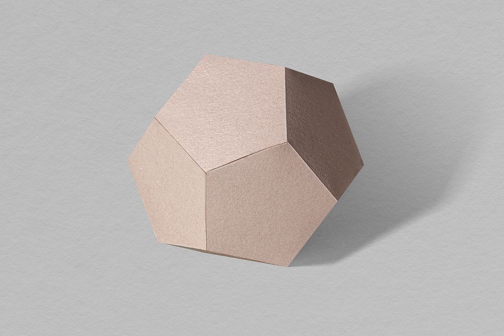 3D pink pentagon shaped paper craft on a gray background