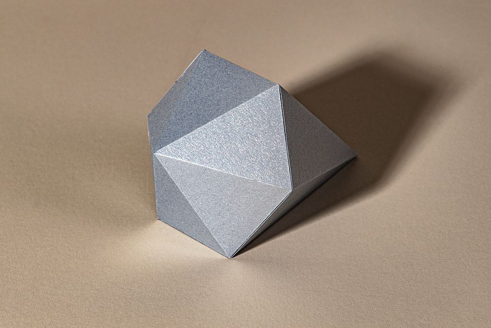 3D gray diamond shaped paper craft on a gray background