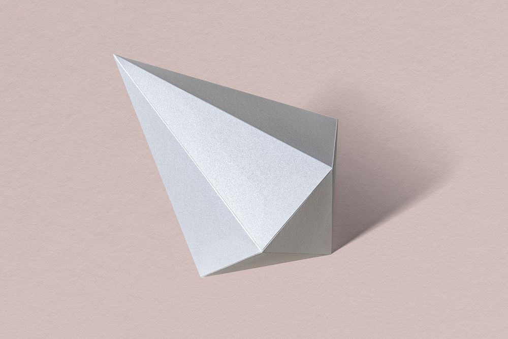 3D silver asymmetric hexagonal bipyramid paper craft on a dull pink background