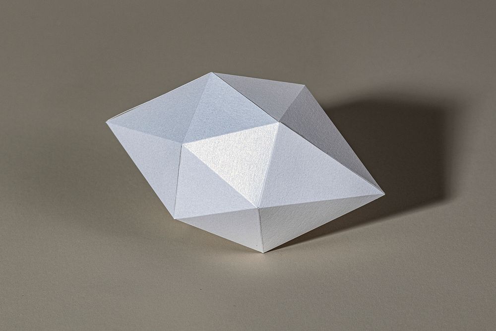 3D silver octahedral polyhedron shaped paper craft on a gray background