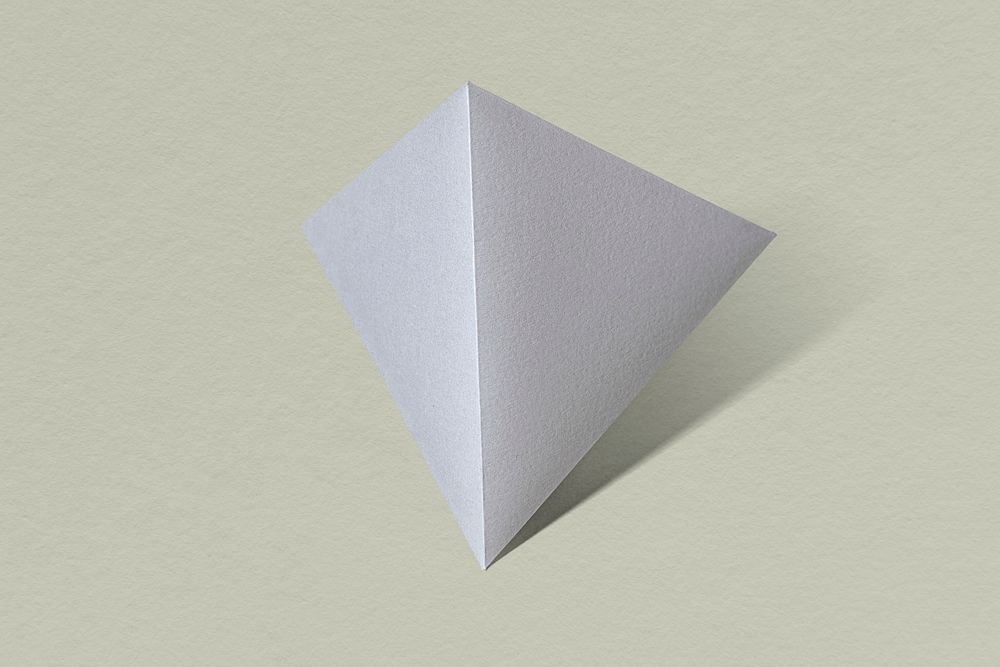 3D silver pyramid paper craft on a sage green background