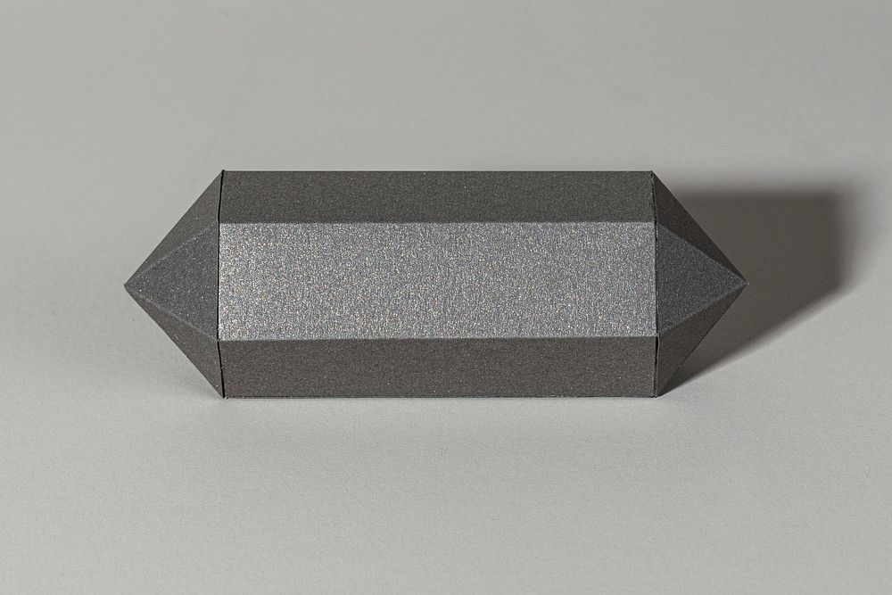 Gray hexagonal prism paper craft on a gray background