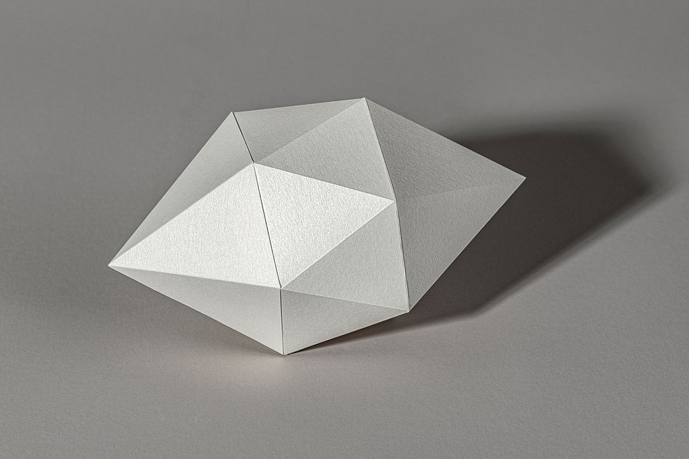 3D silver octahedral polyhedron shaped paper craft on a gray background 