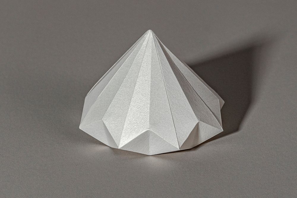 3D silver diamond shaped paper craft on a gray background