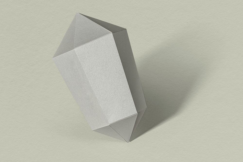Silver hexagonal prism paper craft on a sage green background