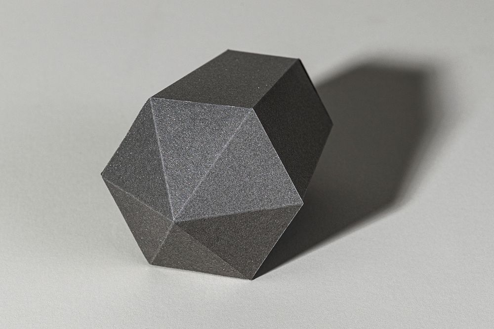 Gray hexagonal prism paper craft on a gray background