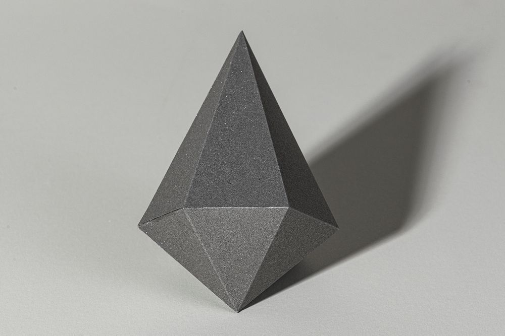 3D gray asymmetric hexagonal bipyramid paper craft on a gray background