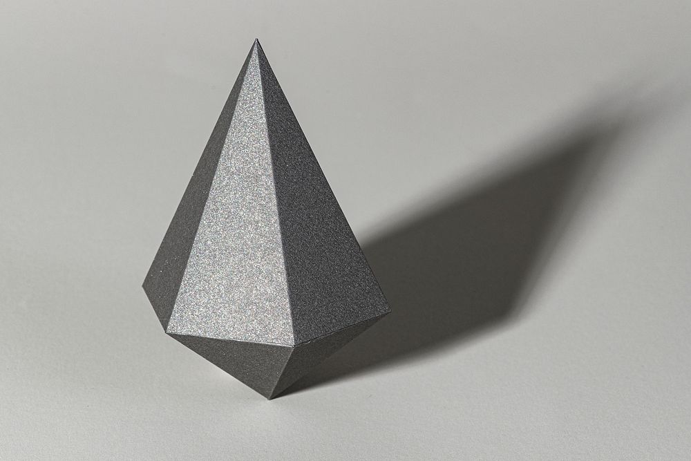 3D gray asymmetric hexagonal bipyramid paper craft on a gray background