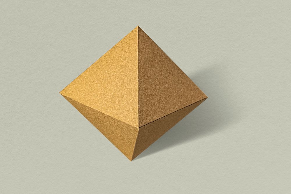 3D golden pyramid paper craft on a sage green background
