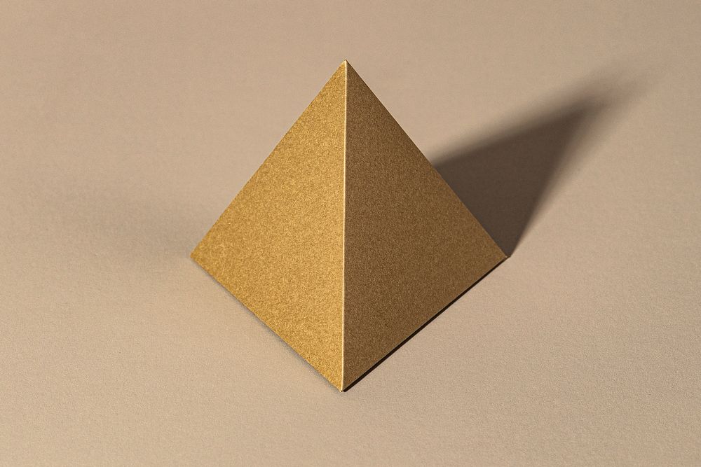 3D golden pyramid paper craft on a beige background