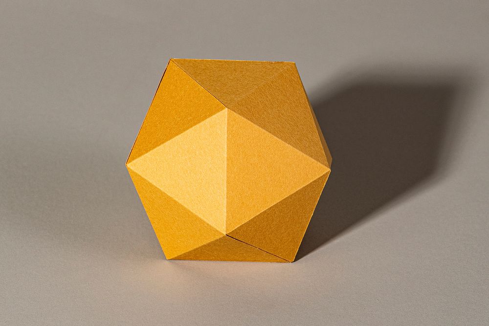 3D golden hexagon shaped paper craft on a gray background