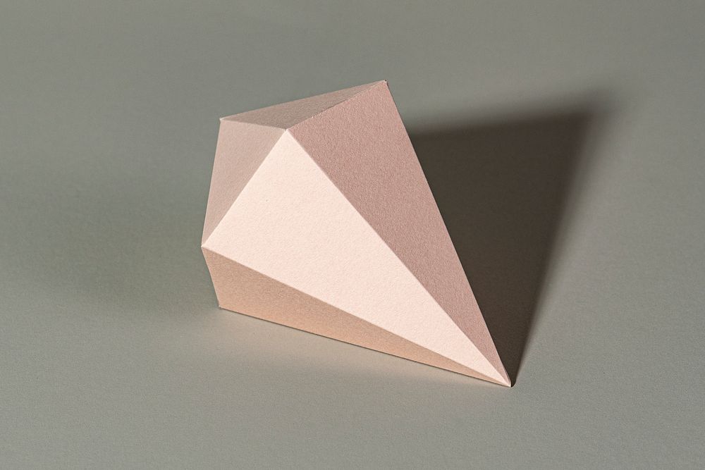3D pink asymmetric hexagonal bipyramid paper craft on a gray background