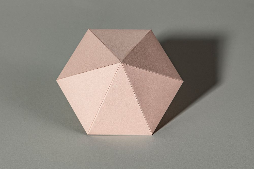 3D pink diamond shaped paper craft on a gray background