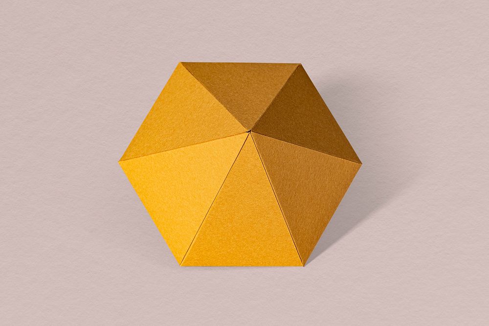 3D golden diamond shaped paper craft on a dull pink background