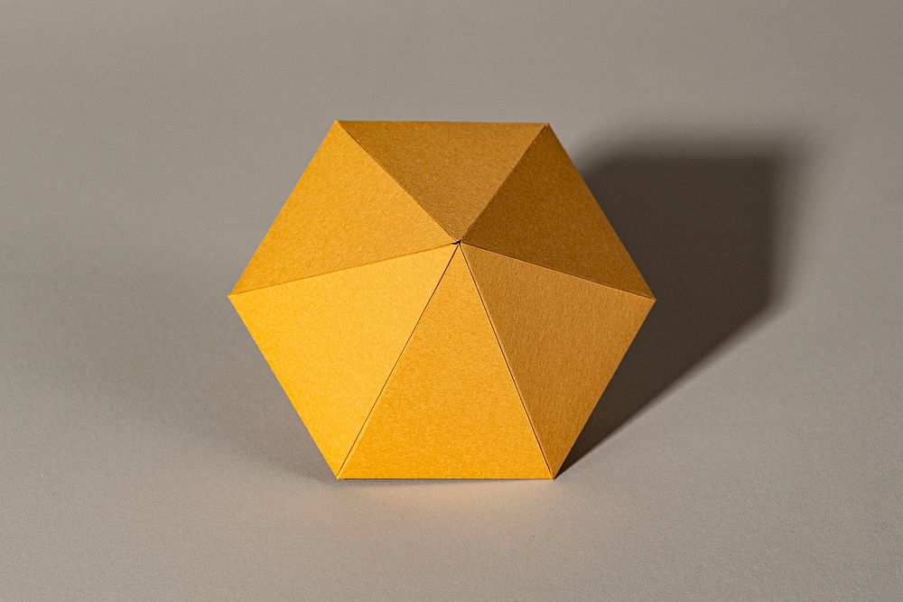 3D golden diamond shaped paper craft on a gray background