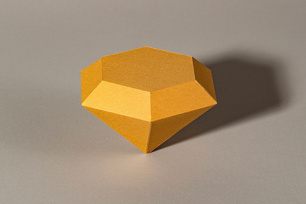 3D golden diamond shaped paper craft on a gray background