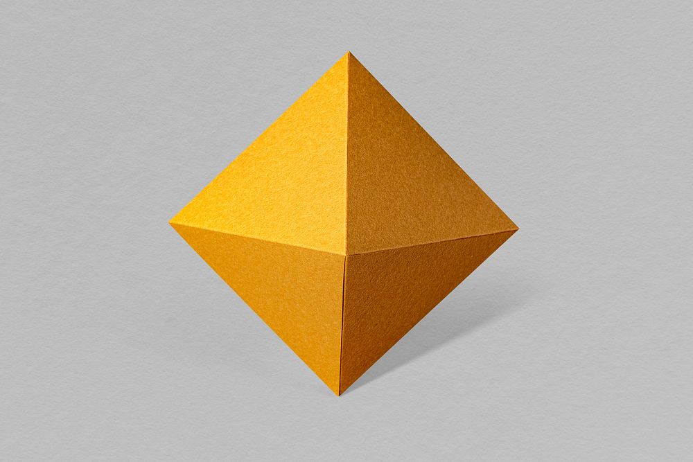 3D golden pyramid paper craft on a gray background