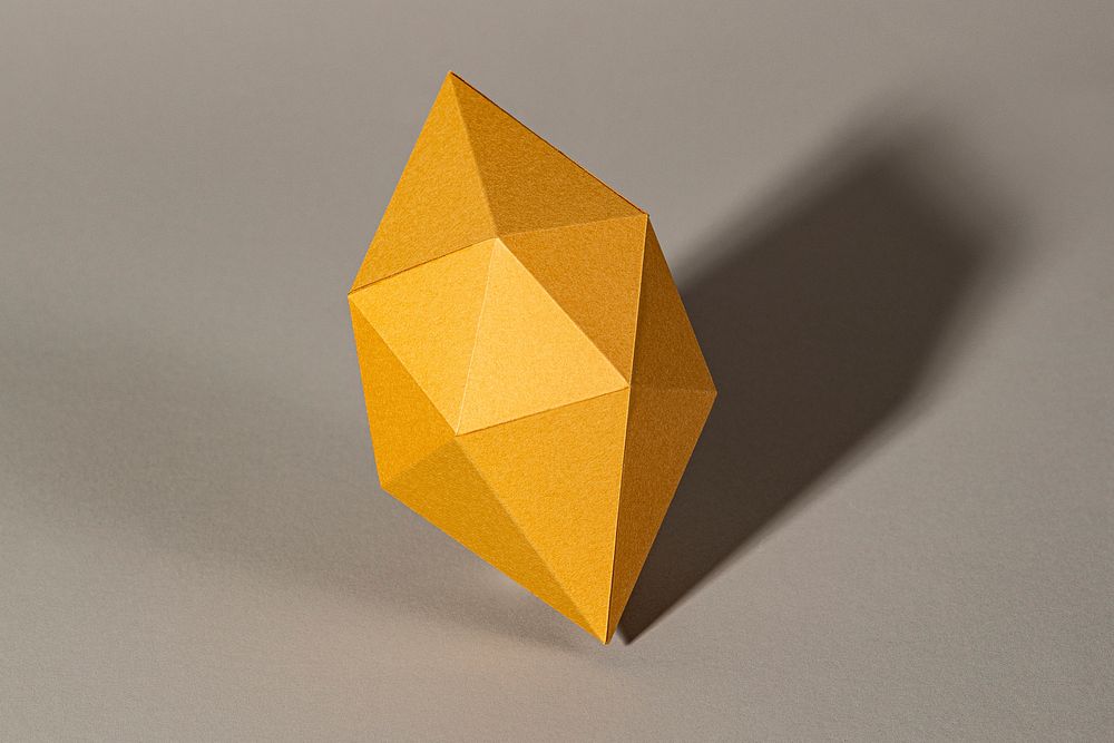 3D golden octahedral polyhedron shaped paper craft on a gray background 