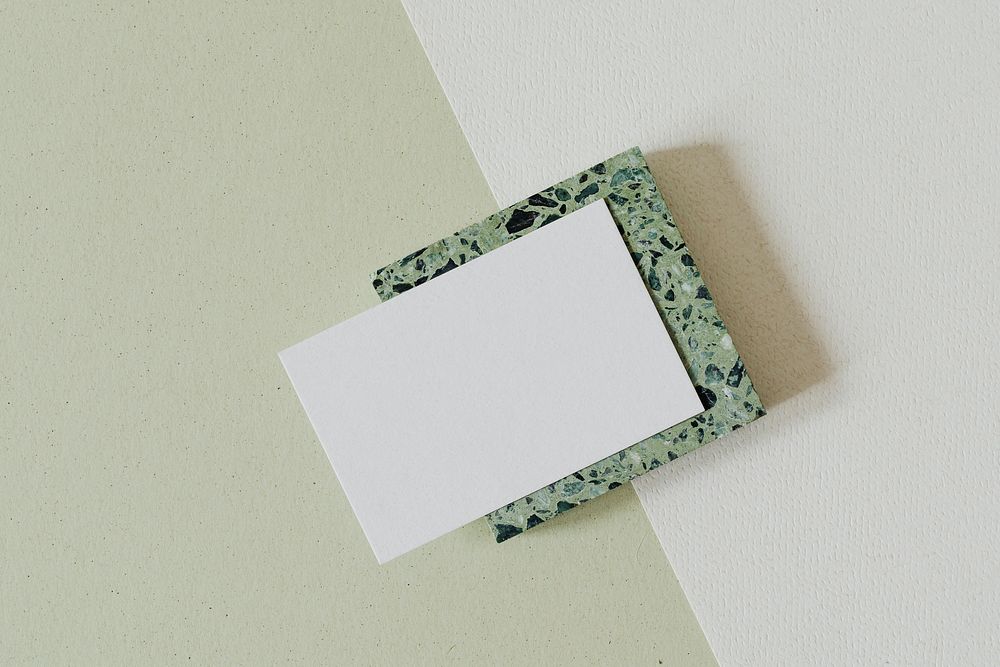 Blank white name card on green granite cube