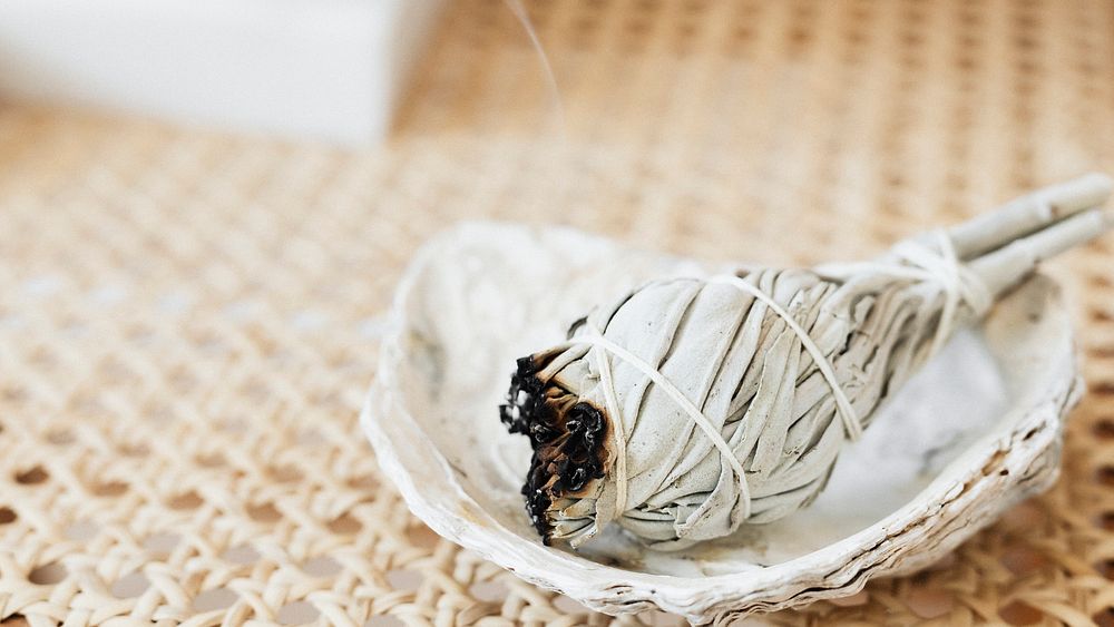 Burning sage smudge to cleanse the house
