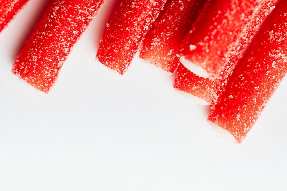 Red chewy candies coated with sugar