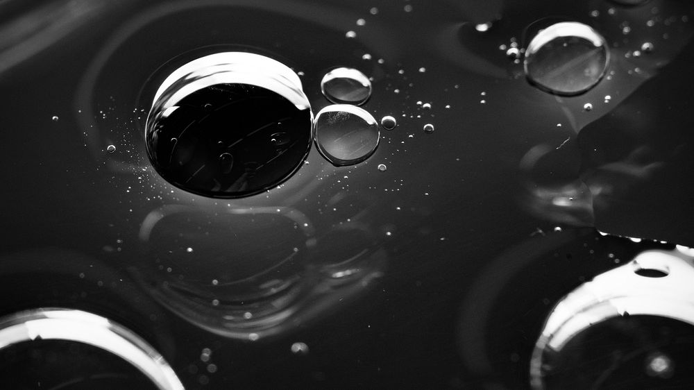 Oil drops floating on water background