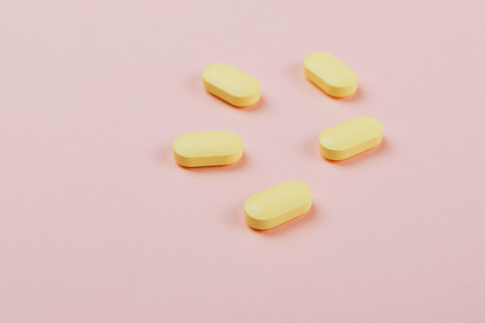 Medicine and pills on a pink background