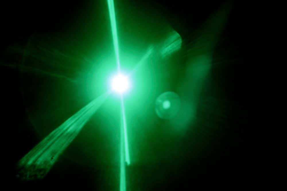 Green flare light effect design element on a black background