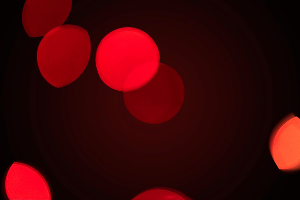 Red bokeh pattern design element on a dark background