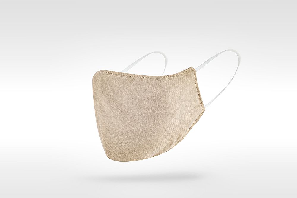 Beige fabric face mask on a gray  background