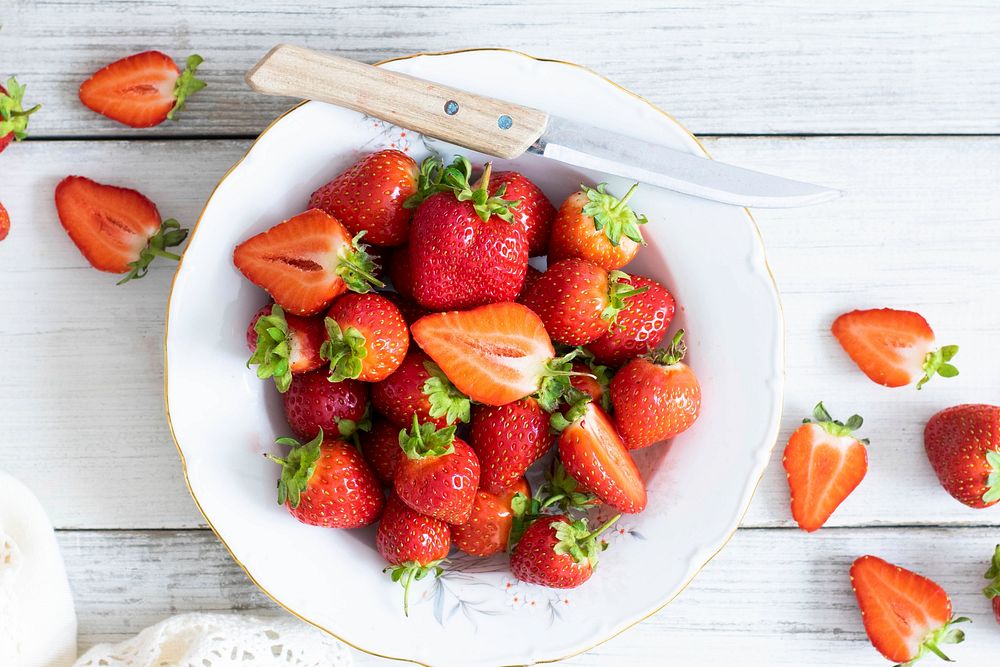 Strawberry plate with knife flat lay