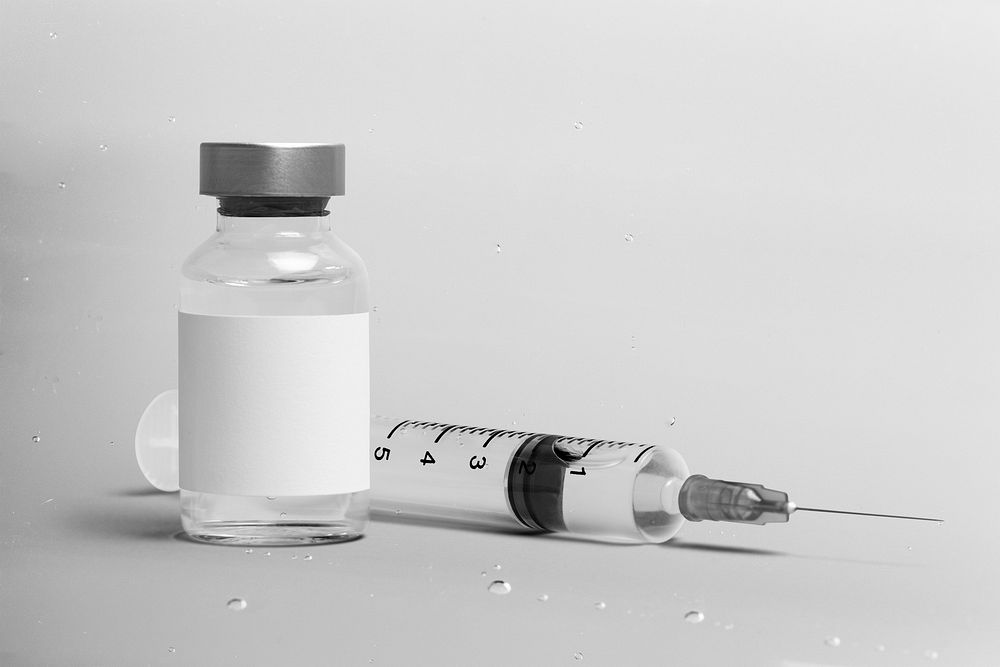 Blank white label on injection bottle glass vial with syringe