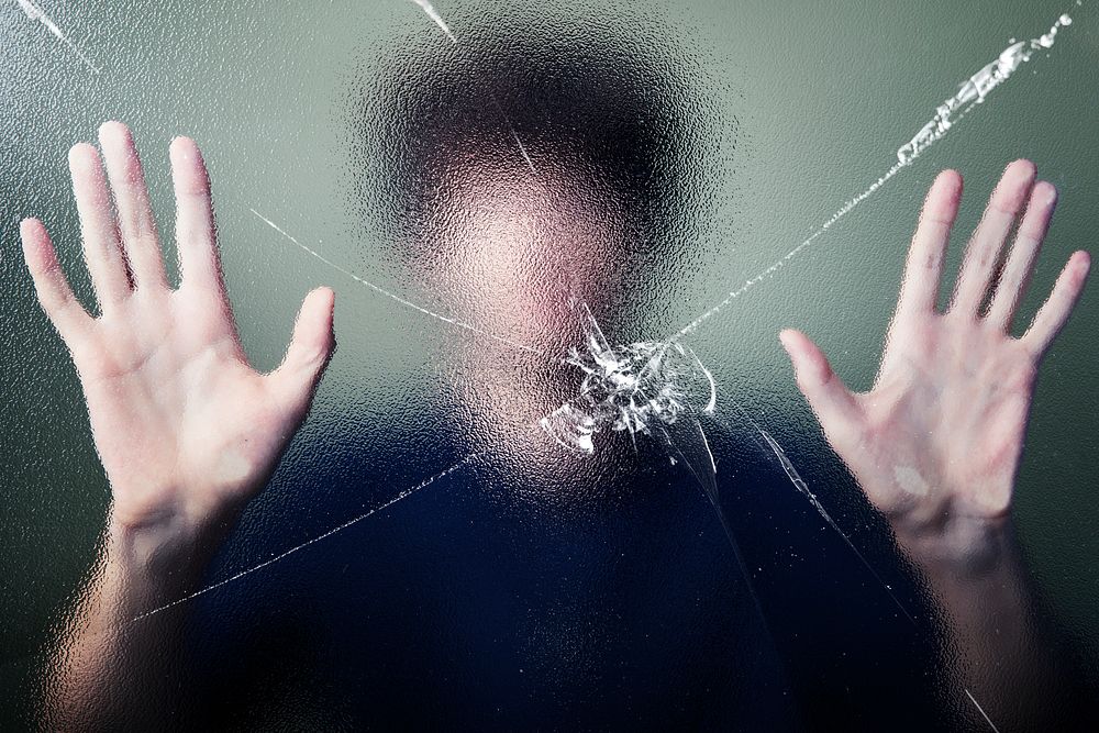 Anonymous man with cracked glass effect