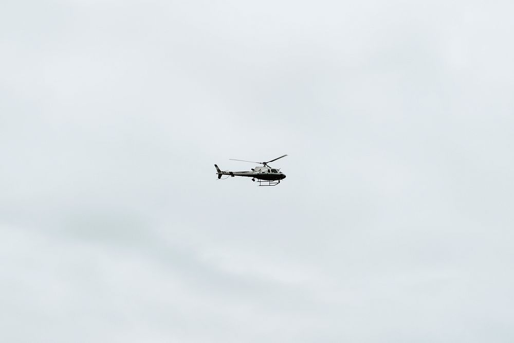 Helicopter flying in a cloudy sky