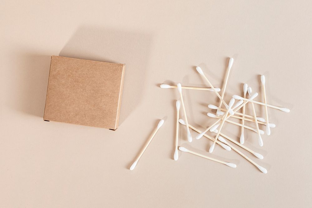 Natural cotton buds and brown packaging
