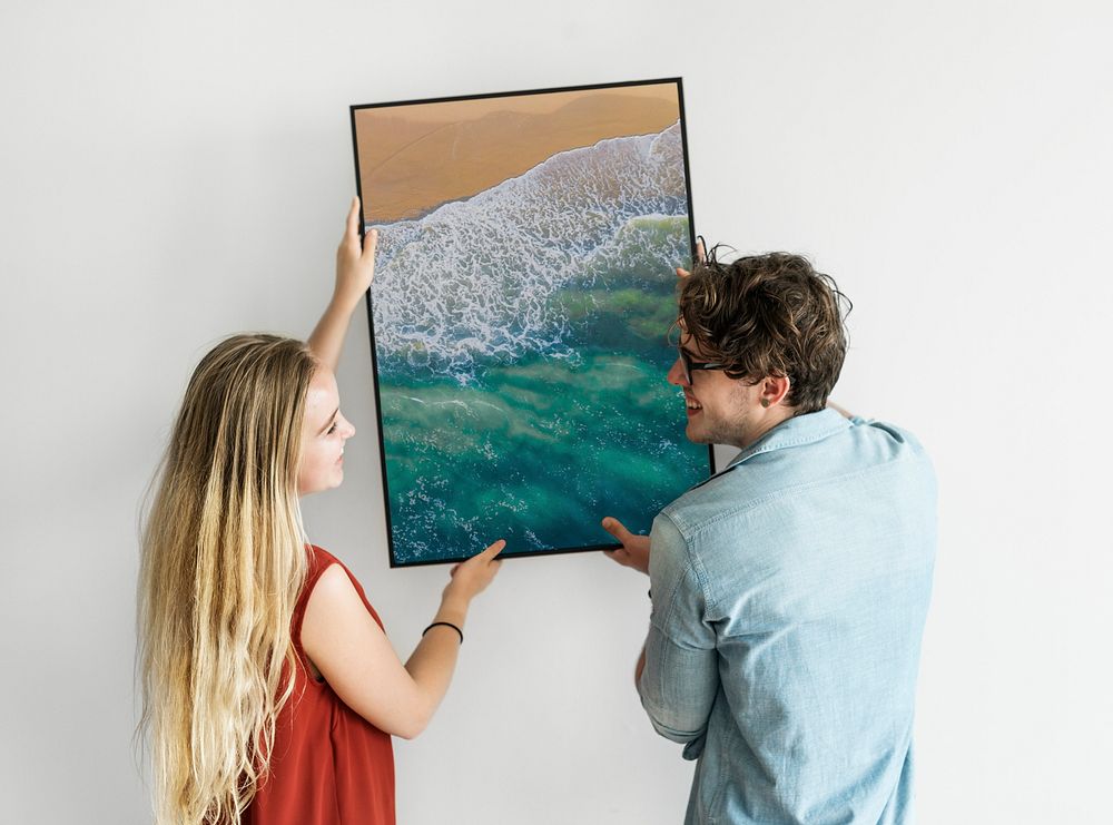 Couple holding picture frame mockup, wall decoration psd