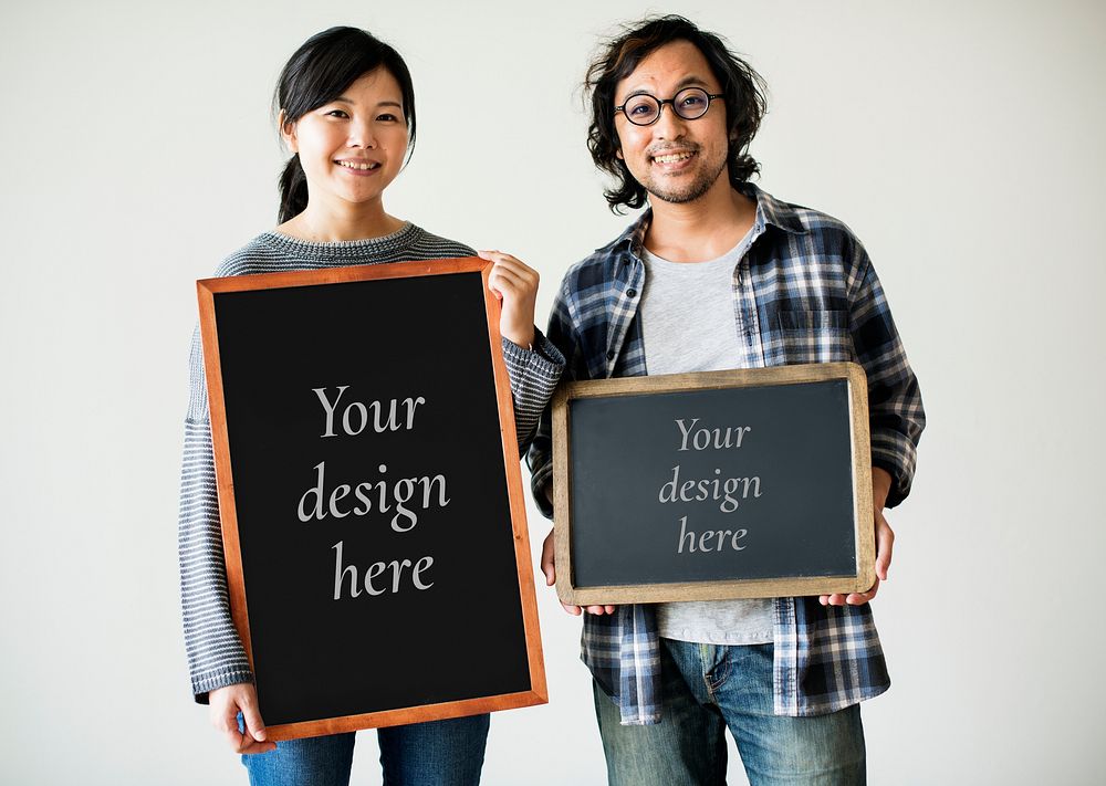 Asian couple is holding blackboard mockups