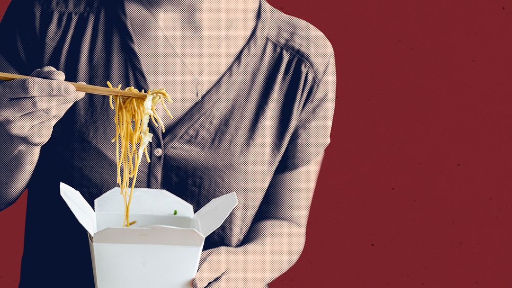 Woman eating a box spaghetti